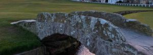 Historic Swilcan Bridge on the Old Course at St Andrews golf course in Scotland at sunset.