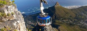 Table Mountain cable car overlooking Cape Town coastline and surrounding mountains in South Africa.
