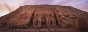 Front view of the colossal statues at the Temple of Abu Simbel carved into a mountainside in Egypt.