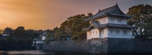 Tokyo Imperial Palace surrounded by stone walls, trees, and calm moat waters in Chiyoda, Tokyo.