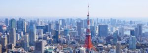 Panoramic skyline view of Tokyo featuring Tokyo Tower surrounded by modern skyscrapers in Japan.