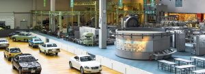 Classic Toyota vehicles and industrial exhibits displayed inside the Toyota Museum in Nagoya, Japan.