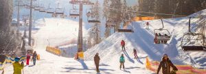 Skiers enjoying snowy slopes at Tsaghkadzor Ski Resort during winter
