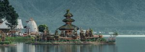 Ulun Danu Beratan Temple on Lake Beratan in Bali, Indonesia, surrounded by mountains and lush tropical scenery.
