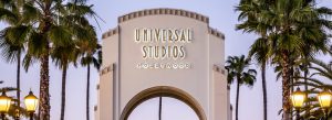 Entrance arch of Universal Studios Hollywood surrounded by palm trees in Los Angeles, California.
