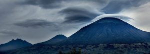 Storm clouds and lenticular clouds above volcanic peaks in Volcanoes National Park, Rwanda