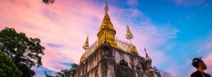 Golden stupa of Wat Chom Si on Phousi Hill at sunset in Luang Prabang, Laos