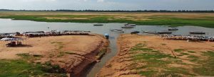 Boats and riverside stalls along West Baray lake in Siem Reap, Cambodia
