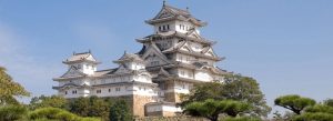 Himeji Castle in Japan, also known as White Heron Castle, featuring elegant white walls and traditional Japanese castle architecture under a clear blue sky.