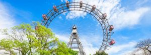 Wiener Riesenrad giant Ferris wheel at Prater amusement park in Vienna Austria on a sunny day with blue sky and green trees