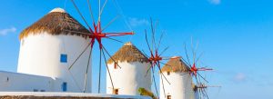 Historic windmills of Kato Mili under a blue sky in Mykonos, Greece