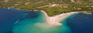 Aerial view of Zlatni Rat beach in Bol with turquoise Adriatic Sea and sandy peninsula in Croatia