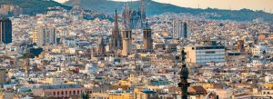 Aerial view of Barcelona cityscape with the iconic Sagrada Família rising above the urban skyline in Spain.