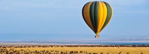 Hot air balloon flying above the Maasai Mara during the Great Migration safari in Kenya