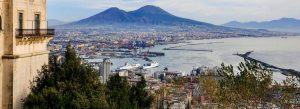 View of Mount Vesuvius overlooking Naples city and harbor with boats along the Italian coastline