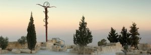 Serpent cross sculpture at Mount Nebo overlooking the Jordan Valley at sunset in Jordan